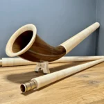 Hochwertiges Alphorn aus Holz mit erlesenen Mundstücken, perfekt für traditionelle Klänge in Alpenlandschaften.