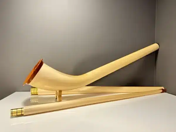 Traditionelles Alphorn aus hellem Holz mit abnehmbaren Mundstücken, perfekt für Heimatklang-Enthusiasten und Naturliebhaber.