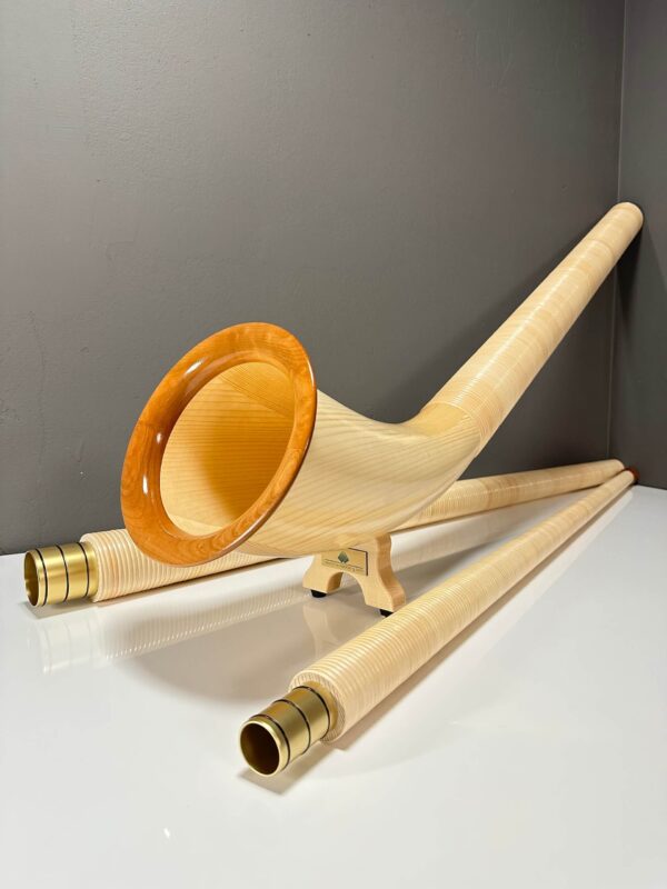 Alphorn mit hochwertigen Holzmundstücken, präsentiert auf weißem Hintergrund, ideal für traditionelle Klänge aus den Alpen.